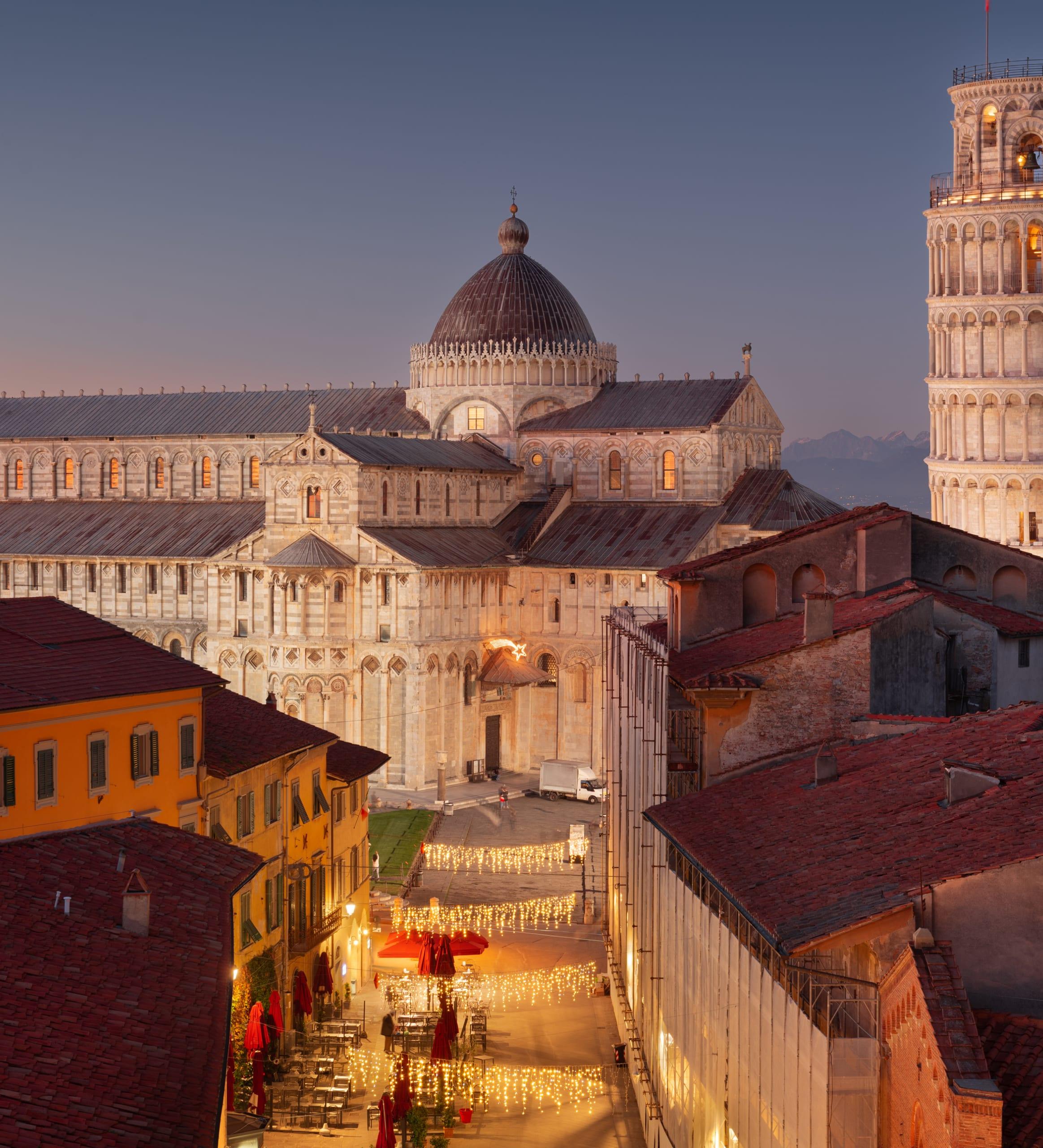 A historic European city square at sunset