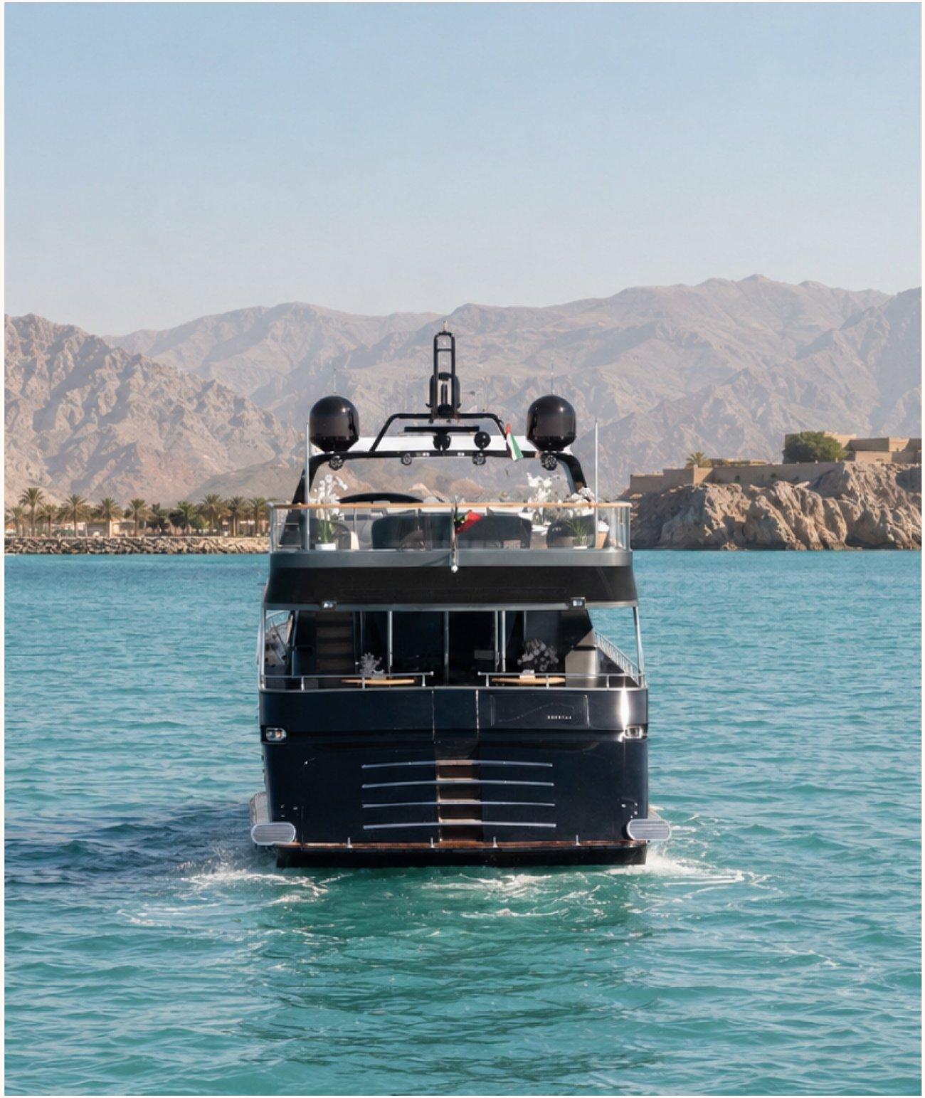 A private yacht at anchor off a rugged coast